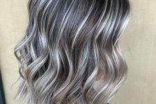 medium-length dark hair with silver greys and silver money piece looks very chic and elegant