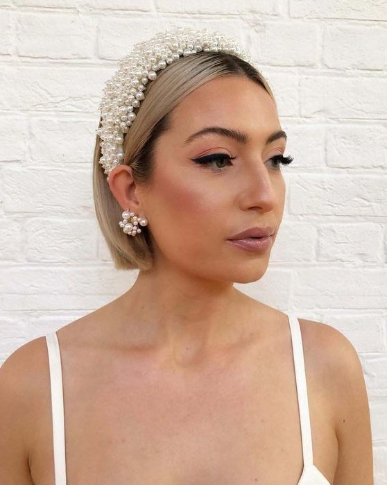 short sleek bob accented with a statement pearl headband and matching earrings for a glam party look