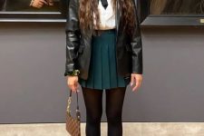 02 a lovely preppy look with a white shirt, a dark green pleated mini, black tights, white socks, black shoes and a black leather jacket
