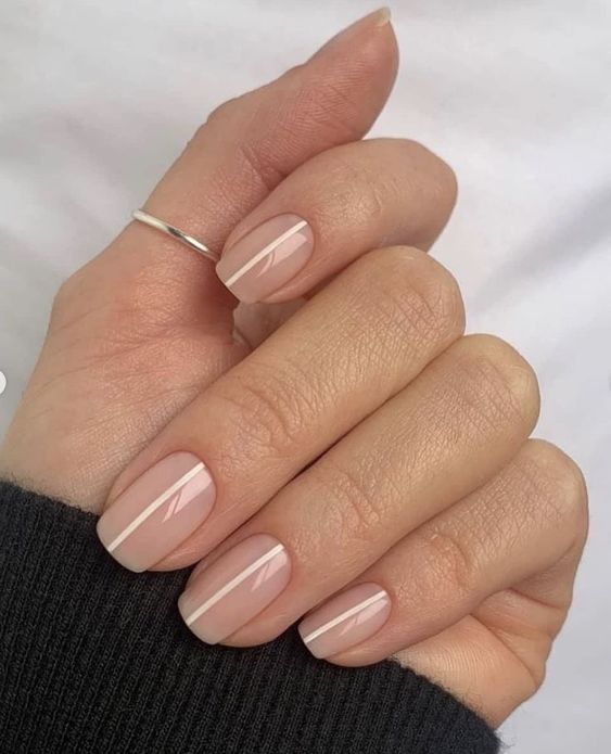 nude square nails with vertical white stripes are amazing for any occasion, it's an alternative to usual nude