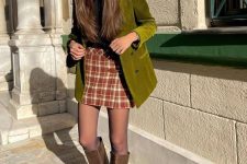 04 a fall-colored preppy outfit with a black turtleneck, plaid mini, brown boots and tights, a green velvet blazer