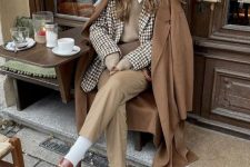 06 a preppy meets old money look with a white shirt, a greige waistcoat, beige pants, white socks, brown loafers and a brown coat