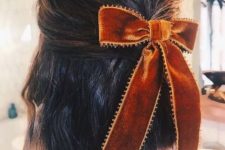09 a long bob styled as a half updo with a rust-colored velvet bow is a stylish idea for Christmas