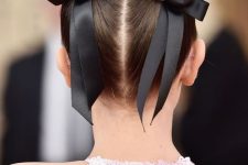 11 space buns accented with black silk bows are a super cool and super stylish hairstyle for a special occasion