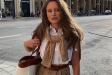 17 an old money spring to summer outfit with a white button down, a beige jumper, beige shorts and a tote