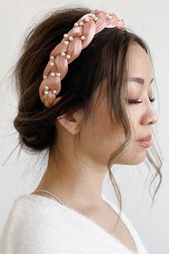 a delicate braided pink headband with pearls is a stylish and chic accessory to wear with girlish looks