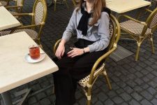 20 a classy old money outfit with a grey shirt, a black pullover, black wideleg pants, black slingbacks