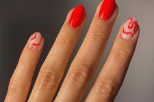 30 a bold red manicure with swirls is a trendy idea, a fresh alternative to classic reds