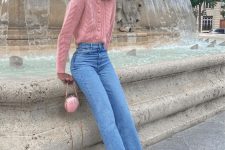 30 a cute ballet-core look with a pink cardigan tucked into blue jeans, pink slingbacks and a small shell-shaped pink bag