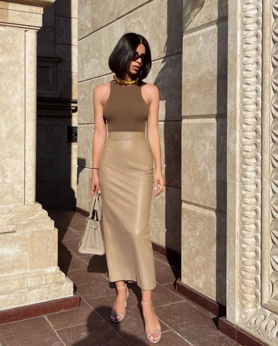 a beautiful and chic summer work look with a taupe sleeveless top, a tan midi skirt, nude shoes and a tan bag