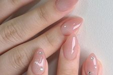 34 glitter nude stiletto nails with rhinestones and pearls on some fingers are a cool idea for a special occasion like a wedding