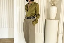35 a lovely office outfit with a green silk button down, olive green wideleg pants, white shoes and a black belt