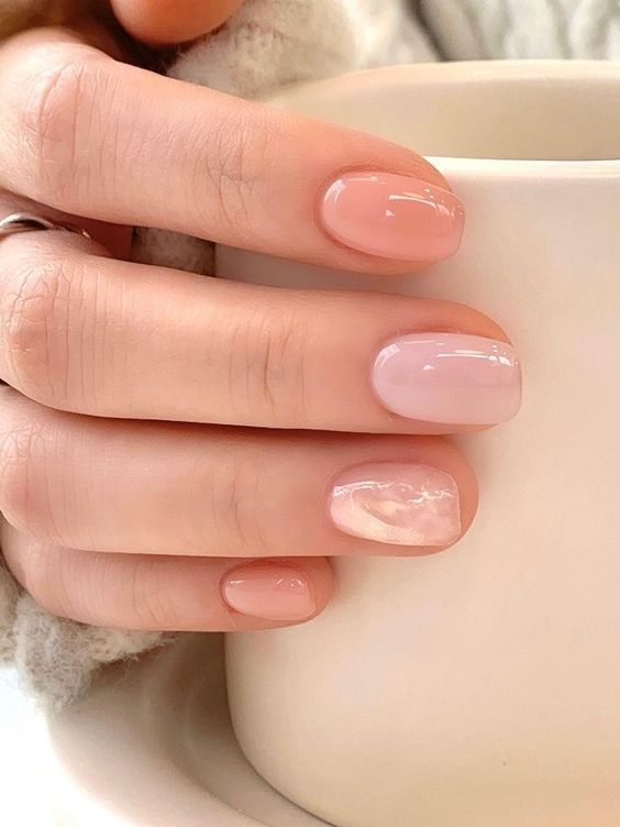a delicate and subtle nude manicure done in soft shades of blush, peachy and chrome is amazing
