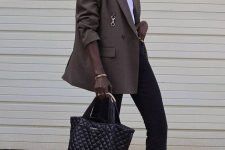 37 black flare jeans, a white t-shirt, a taupe oversized blazer, black shoes and a black bag