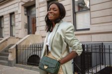 39 a spring work look with a white t-shirt, a pale green oversized blazer, tan leather pants and a green bag