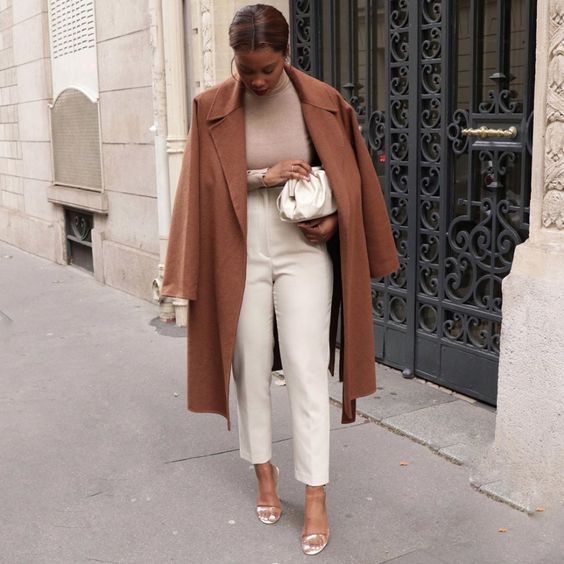 a chic and casual work look with a tan turtleneck, creamy pants and a bag, a brown coat and clear shoes