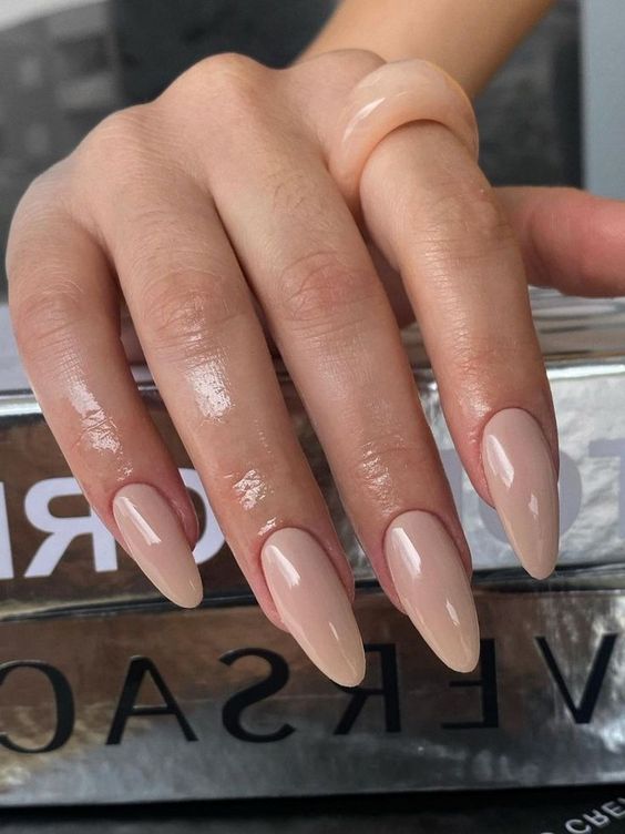 a chic long almond manicure done in an elegant nude shade is always a good idea for any occasion