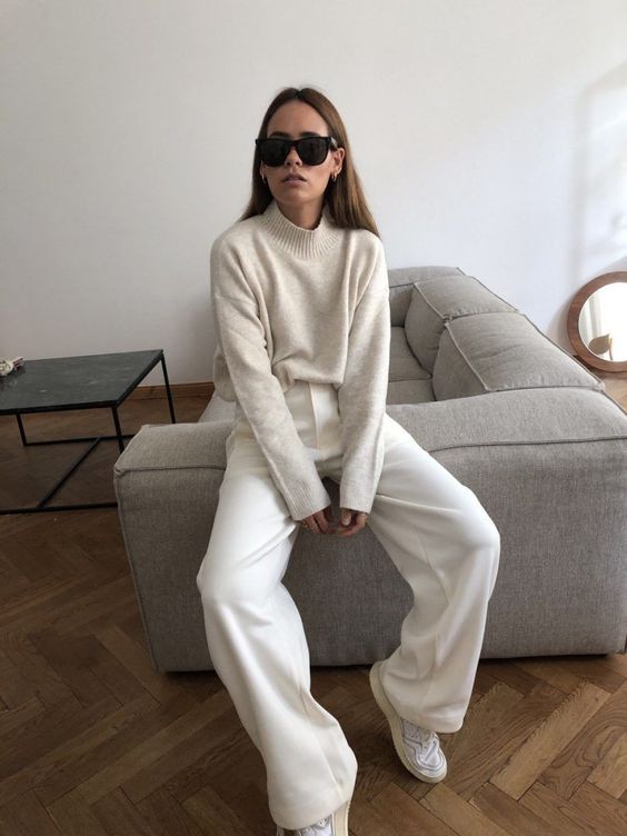 a simple and classy white look with a jumper, trousers and sneakers is all you need for every day