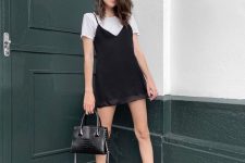 55 a 90s inspired look with a white t-shirt, a black slip mini dress, black chunky boots and a black bag