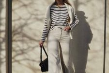 a Breton stripe top, white jeans, nude Mary Jane shoes, a white jumper over the shoulders, a white beret, a black bag