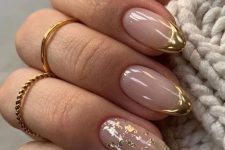 a beautiful and glam version of FRench manicure done on almond nails with gold, gold foil and gold tips is wow