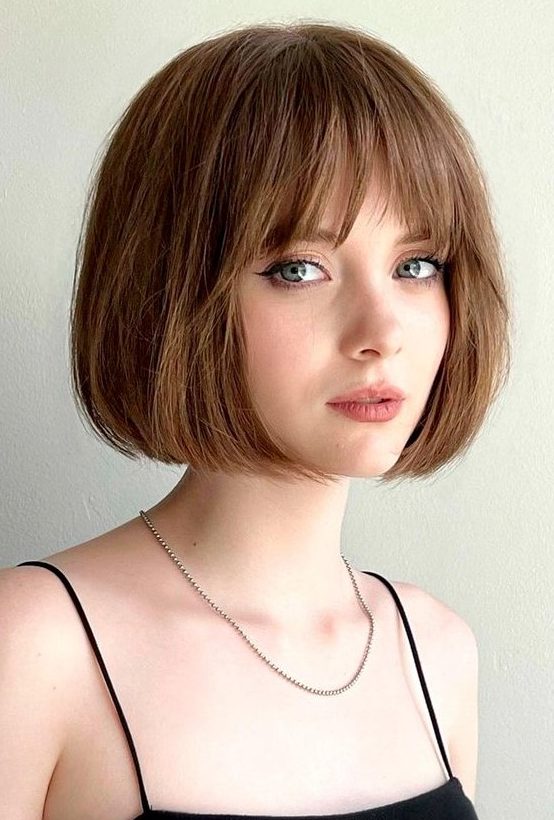 a beautiful mouse brown French bob with a fringe and a lot of volume is a cool and chic idea for everyone who loves classics