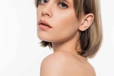 a beautiful mousy brown and bronde long bob with wispy and side bangs that beautifully frame the face