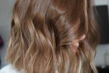 a beautiful shoulder-length light brown bob with blonde highlights and some waves is a cool and stylish idea