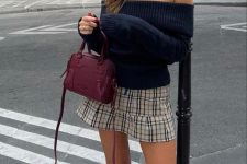 a black off the shoulder jumper, a plaid mini, cherry red Mary Jane flats and a small matching bag