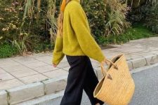 a bold fall look with a mustard sweater, black trousers, red Mary jane shoes and a woven tote
