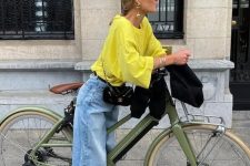 a bold spring look with a yellow long sleeve top, blue baggy jeans, black Mary Jane shoes and a black bag
