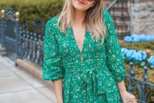 a bright green short dress with a floral print, long sleeves, a plunging neckline and a wicker clutch