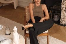 a brown shiny tank top, black wideleg pants, two-tone shoes and statement jewelry for a modern quiet luxury look