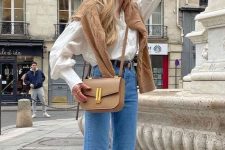 a casual outfit with a white blouse, blue jeans, silver flats, a beige jumper and a beige bag