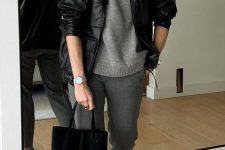 a chic work outfit with a grey jumper and pants, black mary Jane shoes, a black leather bomber, a bag