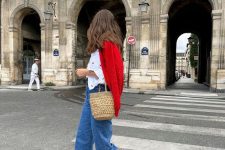 a classic Parisian look with a white shirt, blue jeans, red Mary Jane shoes, a red cardigan and a basket bag