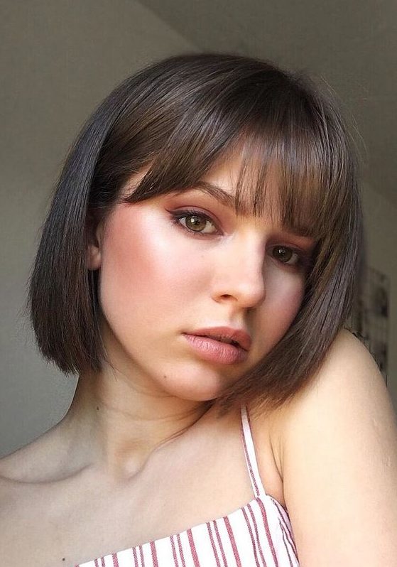 a classy brunette bob with curtain and classic bangs is a veyr cute and very girlish idea