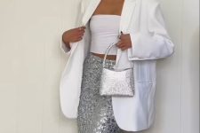 a classy pre-wedding party look with a white strapless top, a silver sequin midi, a white oversized blazer, a silver bag and statement earrings