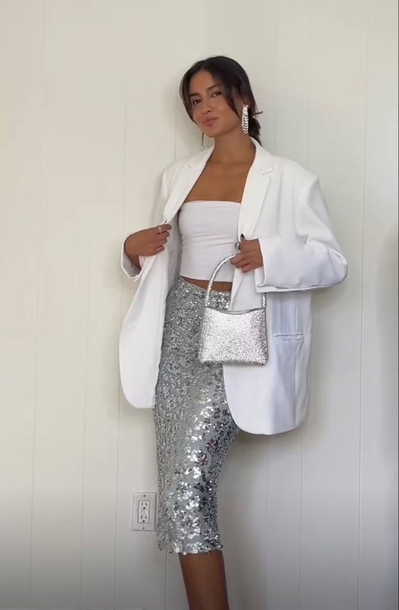 A classy pre wedding party look with a white strapless top, a silver sequin midi, a white oversized blazer, a silver bag and statement earrings