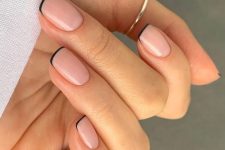 a classy short square manicure, a modern take on French, with thin black tips, is amazing