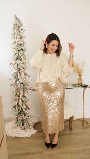 A classy winter pre wedding party look or wedding guest look with a white oversized jumper, a gold sequin maxi, black shoes and some jewelry