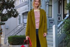 a colorful outfit with a striped top, blue jeans, red Mary Jane shoes, a mustard coat and a red bag