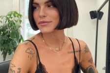 a dark brown jaw-length blunt bob is a cool way to accent your face features