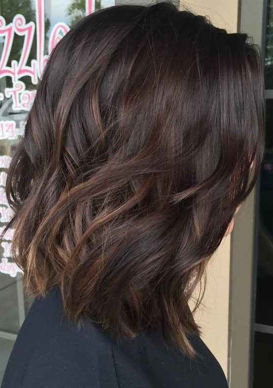 a dark brown wavy bob with caramel highlights is a lovely and chic idea that looks effortless and awesome
