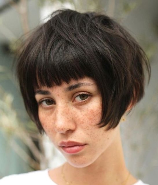 a dark brunette ear-length bob with a classic fringe and a messy volume is a cool solution and this hair is easy to style