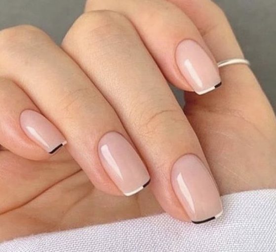 a delicate and modern micro French manicure with black and white micro tips is a very chic idea