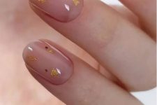 a delicate nude wedding manicure with gold polka dots and gold glitter is a cool and cute idea for glam bridal looks