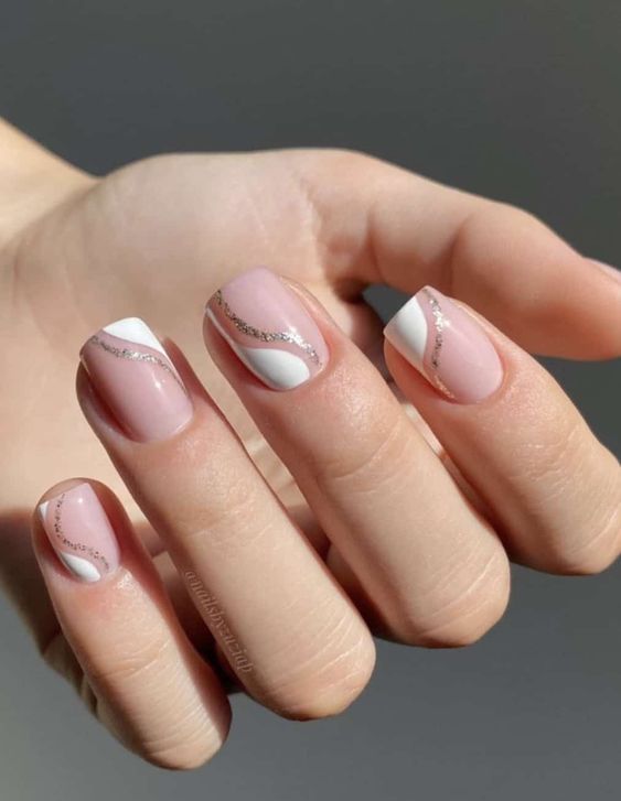 a fresh and glam take on French manicure done on short square nails, with white and silver glitter waves is wow