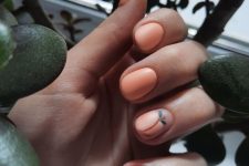 a funny matte Peach Fuzz manicure with a peach accent nail are a cute and sweet idea for summer