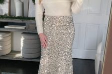 a glam party look with a white off the shoulder jumper, a gold sequin midi, silver heels is amazing